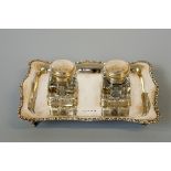 AN EDWARD VII SILVER DESK STAND, shaped rectangular form with a pair of glass inkwells, Henry