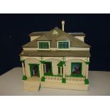 A LARGE WOODEN DOLLS HOUSE, modelled as a two storey Edwardian Villa with steps and balcony to