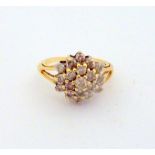 A DIAMOND CLUSTER RING, with brilliant cut diamonds of daisy shape design, estimated total diamond