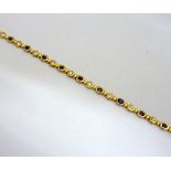 A 9CT GOLD BRACELET, comprising of clear and blue paste stones with concealed clasp, length 19cm,