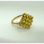 A 9CT GOLD YELLOW SAPPHIRE CLUSTER RING, within kite shape to the plain tapered band, hallmarks