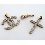 THREE PENDANTS, to include a replica Chanel symbol pendant, a cross and a hand holding a gemstone,