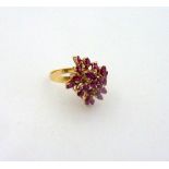 A RUBY CLUSTER DRESS RING, designed as a spray of marquise and round shape rubies to a plain band,