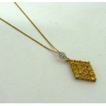 A PENDANT NECKLACE, with diamond and yellow sapphire kite shape pendant to the trace chain,