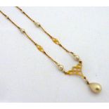 A PEARL NECKLACE, with tear drop shape pearl to a fancy frame work detail to the pearl junction