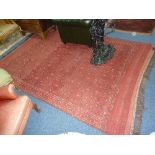 A RED GROUND CARPET, approximate size 315cm x 210cm and another rug (2)