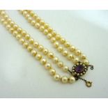 A PEARL NECKLACE, comprising of a double row of pearls with an amethyst cluster clasp within a