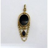 A 9CT GOLD ONYX PENDANT, of oval shape with further oval dropper and swags, hallmarks for Edinburgh