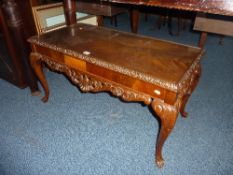 A CARVED MAHOGANY COFFEE TABLE