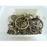 A SMALL TUB OF MIXED SILVER AND WHITE METAL JEWELLERY, to include bangles, bracelets, earrings etc
