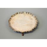 A SILVER PIE CRUST TRAY, on three feet, London 1906, Hawksworth, Eyre & Co, weight approximately