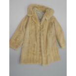 A FUR COAT, with white fur, medium length approximate size 10-12