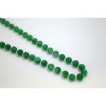 A STRAND OF JADE BEADS, comprising of seventy-two beads, length 70cm