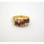 AN 18CT GOLD RUBY AND DIAMOND RING, the five square shape rubies on an abstract twist with