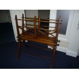 A LATE REGENCY WALNUT FOLIO STAND, the lattice work and turned spindle sides, one being adjustable