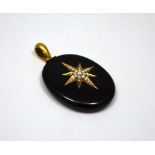 A MEMORIAL LOCKET, designed as an oval shaped black enamel panel with large star to the front with