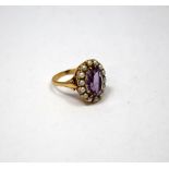 A 9CT GOLD AMETHYST AND PEARL CLUSTER RING, with central oval shape amethyst within a surround of