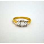 AN 18CT GOLD DIAMOND RING, with three emerald-cut diamonds to plain band, estimated total diamond