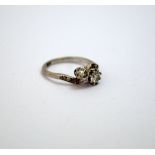 A DIAMOND RING, comprising of two old-cut diamonds on a twist with old-cut diamond accents,