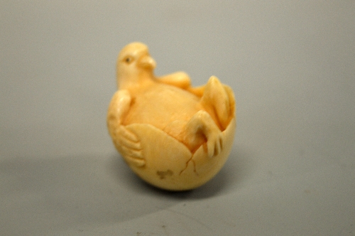 A JAPANESE IVORY NETSUKE, carved in the form of a bird relaxing in an egg, signed to base - Image 2 of 4