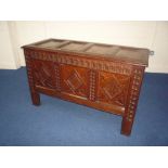 A GEORGIAN CARVED OAK TRIPLE PANEL BLANKET CHEST, the top with four plain panels, candle box to