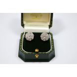 A PAIR OF DIAMOND EARRINGS, designed in a flower shape, each earring comprising of nine old-European