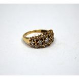 A 9CT GOLD DIAMOND RING, with five graduated brilliant cut diamonds within a surround of smaller