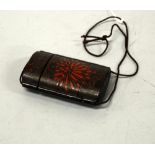 A RED AND BLACK LACQUER FOUR DIVISION INRO, with foliate decoration, approximate height 7.5cm