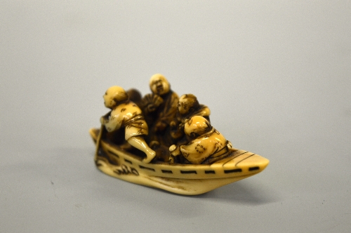 A JAPANESE IVORY NETSUKE, of five men in a boat, signed to base - Image 2 of 3