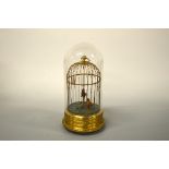 A GILT BIRD CAGE, automaton with two singing birds sat on perches, under glass dome, approximately