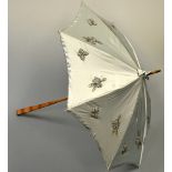 A SILK LADIES PALE BLUE PARASOL, with beadwork butterfly and floral applique, shaped handle