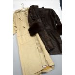 TWO LEATHER COATS, the first a long cream leather coat, the second a long brown leather coat with