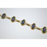 A 9CT GOLD OPAL BRACELET, comprising of five oval shape opals within an abstract setting for each,