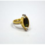 AN 18CT GOLD TOURMALINE AND DIAMOND RING, bi-coloured, the oval tourmaline flanked by brilliant-