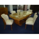 AN ART DECO WALNUT DINING ROOM SUITE, comprising table with shaped stretcher, six chairs to