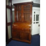 AN EDWARDIAN WALNUT CYLINDER BUREAU BOOKCASE, with double glazed doors to the upper section,