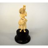 A LATE 19TH CENTURY IVORY OF GIRL HOLDING AN URN,  on a plinth, approximate height 16.5cm