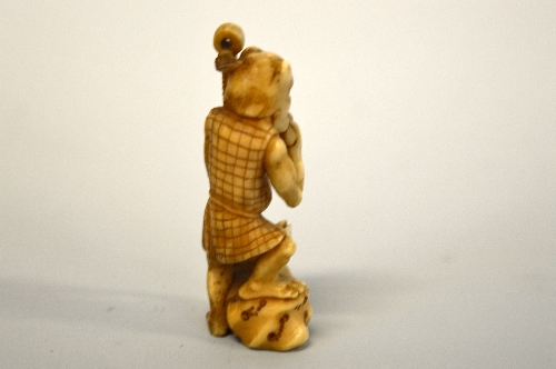 A JAPANESE IVORY NETSUKE, depicting kyogen and a Dog, signed to base - Image 2 of 2