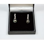 A PAIR OF 18CT GOLD DIAMOND PEARL EAR PENDANTS, with Tahitian pearls suspended from brilliant cut