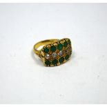 A DIAMOND AND EMERALD RING, with central line of old-cut diamonds, flanked between two rows of