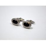 A PAIR OF 18CT GOLD, DIAMOND AND ONYX CUFFLINKS, with oval shape onyx within a surround of