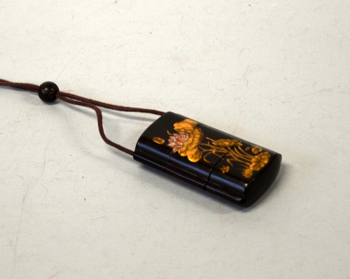 A JAPANESE BLACK LACQUERED THREE DIVISION INRO, decorated with Koi Carp on one side and Lotus flower