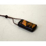 A JAPANESE BLACK LACQUERED THREE DIVISION INRO, decorated with Koi Carp on one side and Lotus flower