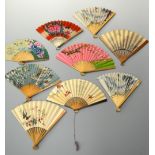 A COLLECTION OF NINE PAPER FANS, to include souvenir fans, floral decoration etc