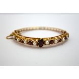 A 9CT GOLD GARNET AND PEARL BRACELET, with central oval shape garnet with alternating pearls and