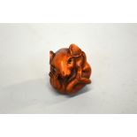 A JAPANESE BOXWOOD NETSUKE, of a Rat, curled into a ball, the eyes inlaid, signed to the base