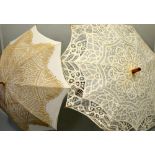 TWO LADIES PARASOLS, with lacework overlays, one with split cane handle and belt and weave detail (