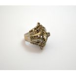 A DIAMOND CLUSTER RING, with central marquise shape diamond within rows of staggered brilliant and