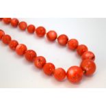 A STRAND OF CORAL BEADS, comprising of thirty-nine graduated coral beads, length 54cm