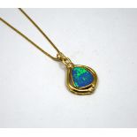 AN OPAL PENDANT NECKLACE, with abstract opal within a plain border with brilliant-cut diamond